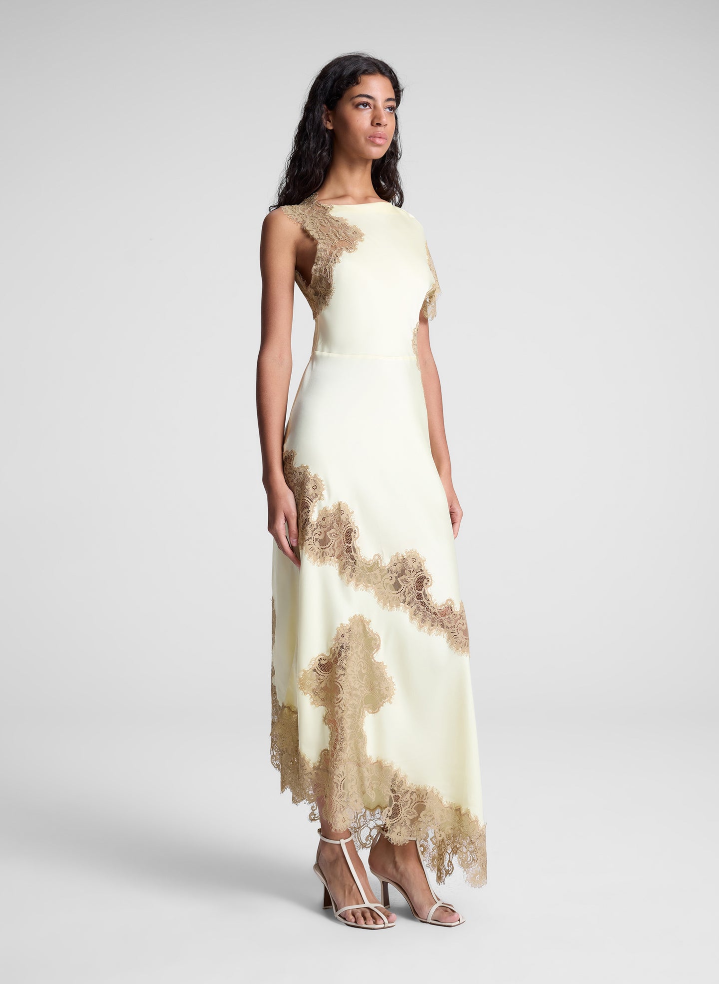 woman wearing butter yellow satin and lace maxi dress