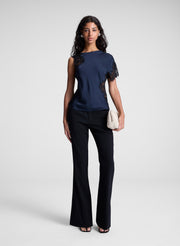 woman holding off white clutch bag