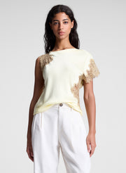 woman wearing butter yellow satin and lace top and cream wide leg pants