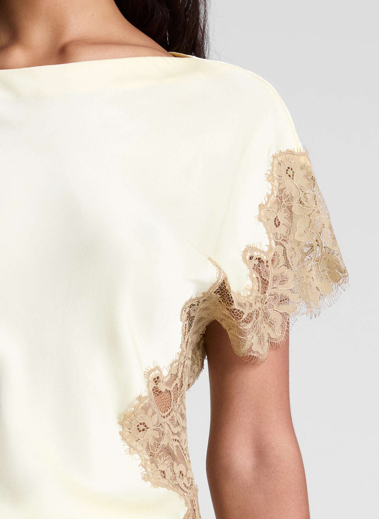 woman wearing butter yellow satin and lace top and cream wide leg pants