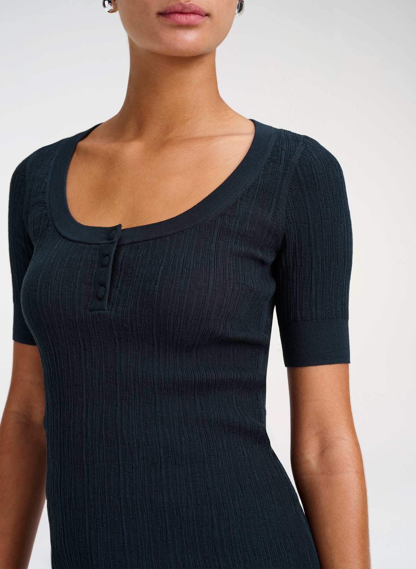 Green ribbed knit top worn by a model on a white background
