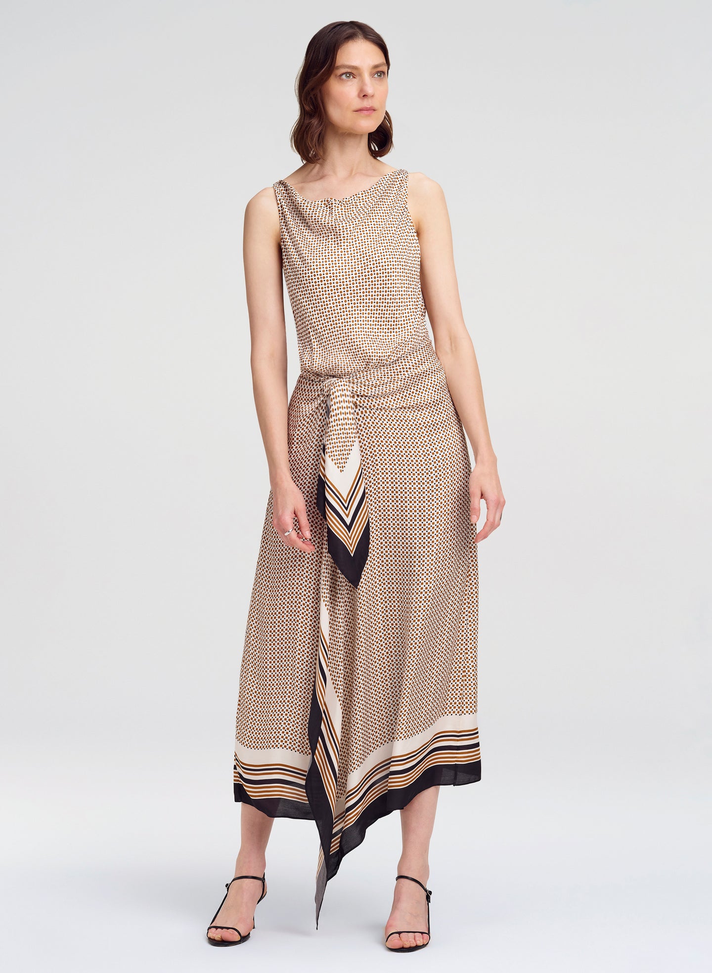 Woman wearing a patterned dress on a white background