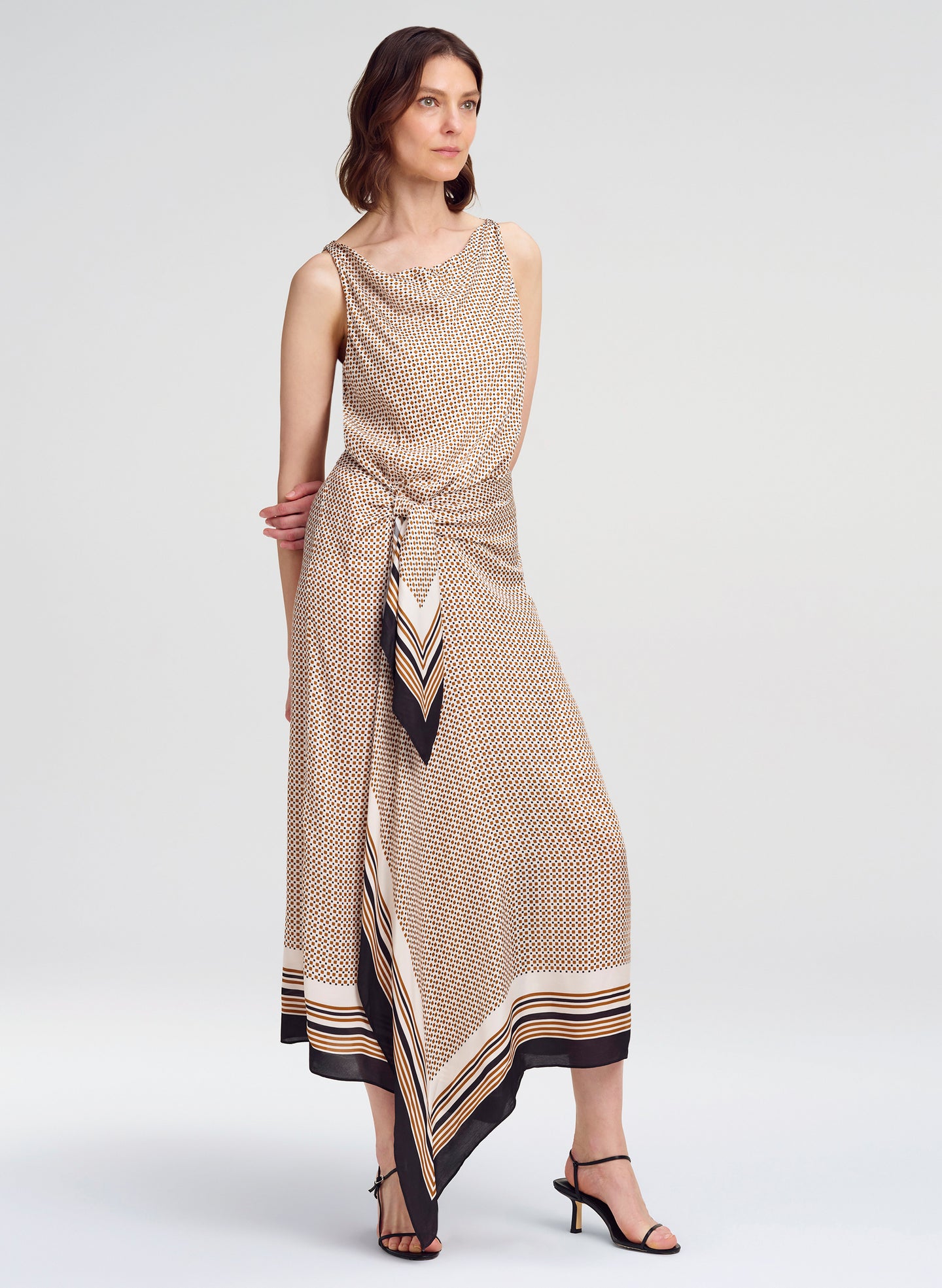 Woman wearing a patterned dress on a white background