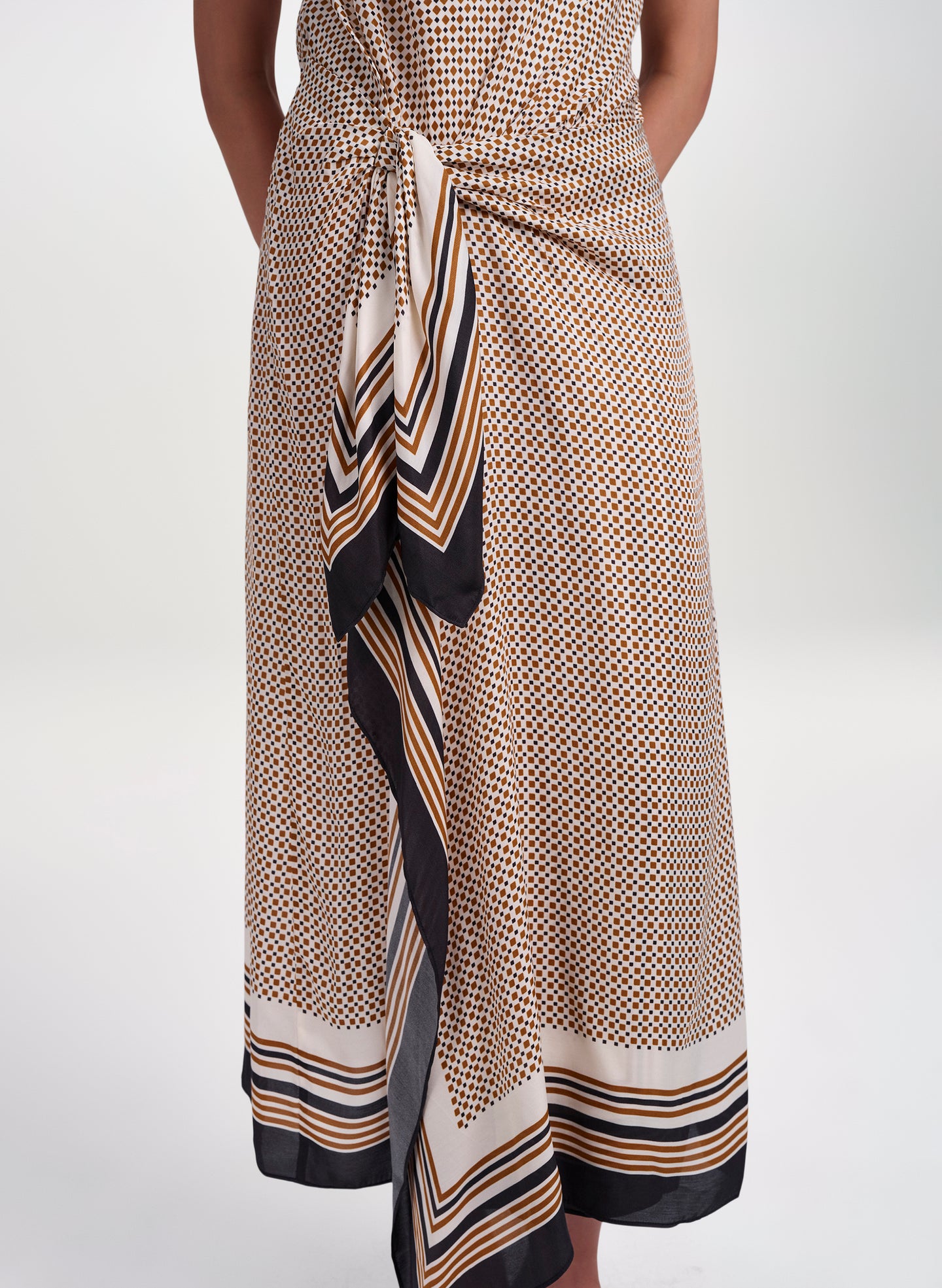 woman wearing scarf print midi dress from waist down