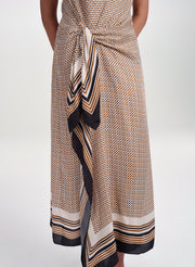 woman wearing scarf print midi dress from waist down