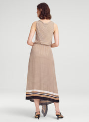 Woman wearing a patterned dress on a white background