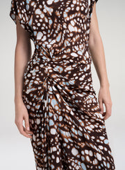 close up of woman in brown print dress