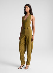 woman wearing green bodysuit and green pants