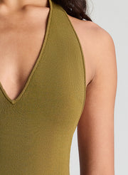 woman wearing green bodysuit and green pants