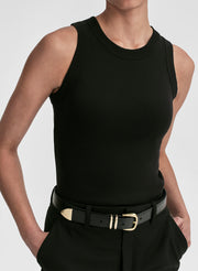 Person wearing a black sleeveless top and black pants with a belt on a light gray background