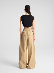 woman wearing back cropped tank and beige wide leg pants