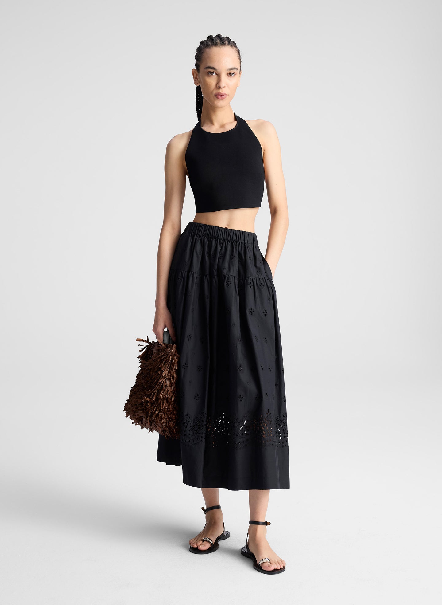 woman wearing black tank top and black eyelet skirt
