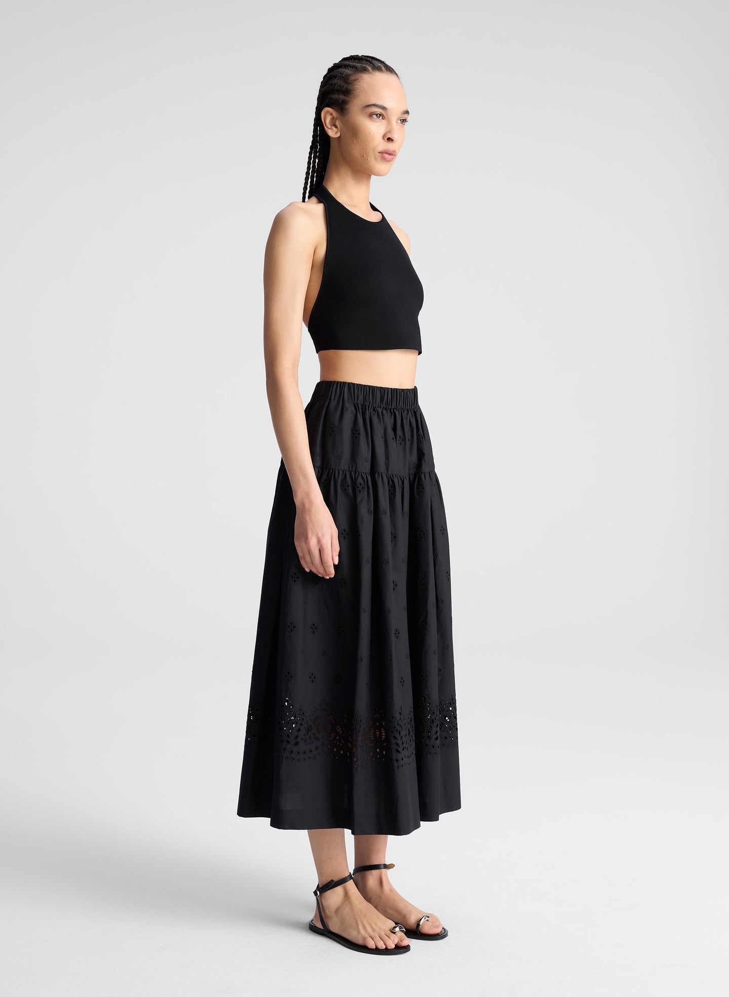 woman wearing black tank top and black eyelet skirt