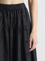 woman wearing black tank top and black eyelet skirt