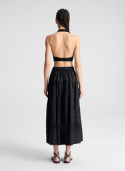 woman wearing black tank top and black eyelet skirt