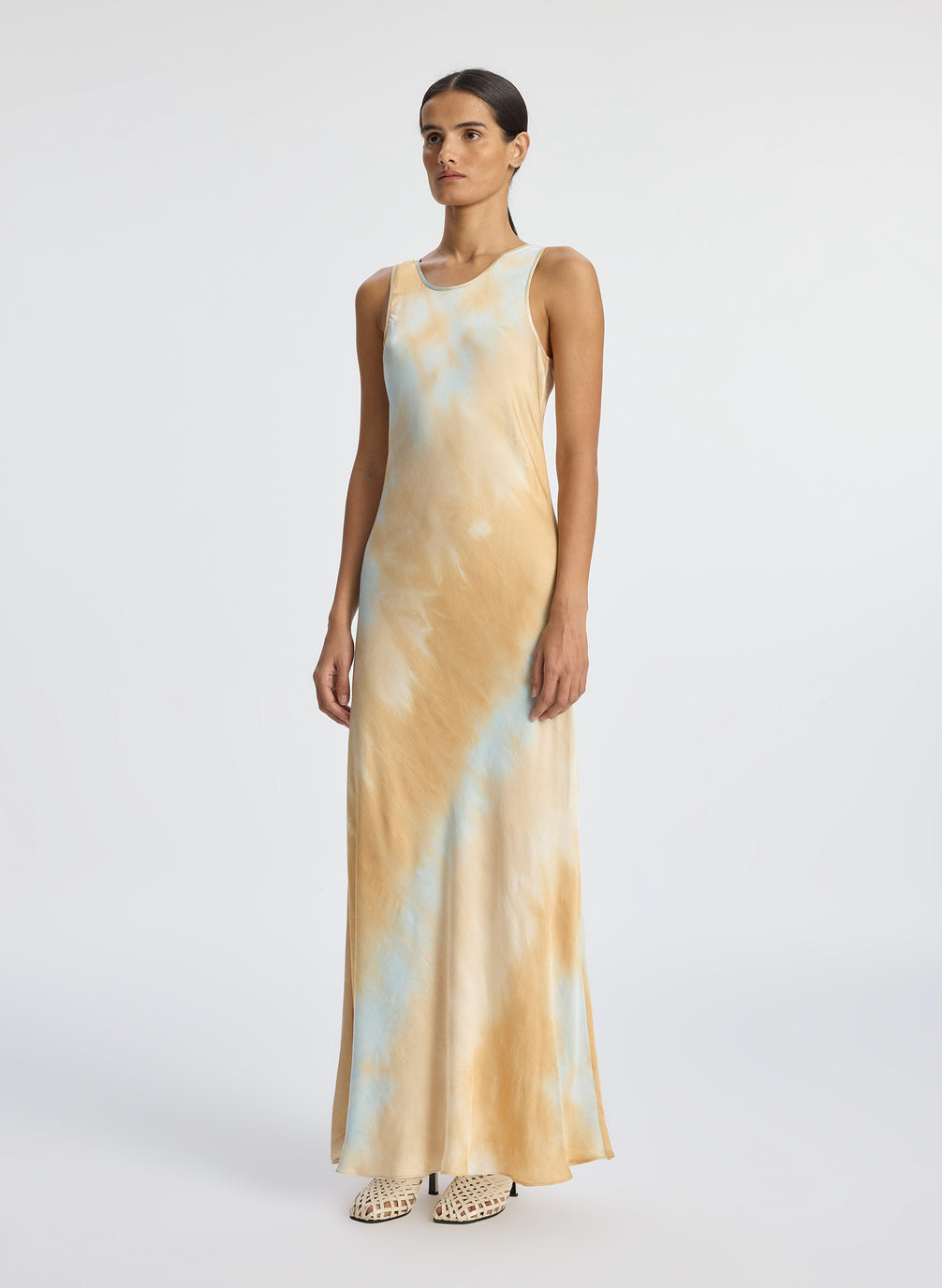 side view of woman wearing blue and beige maxi sleeveless satin dress