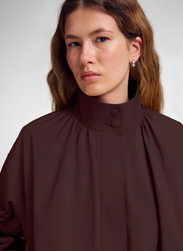 woman wearing ark brown jacket