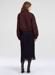 woman in brown jacket and black skirt