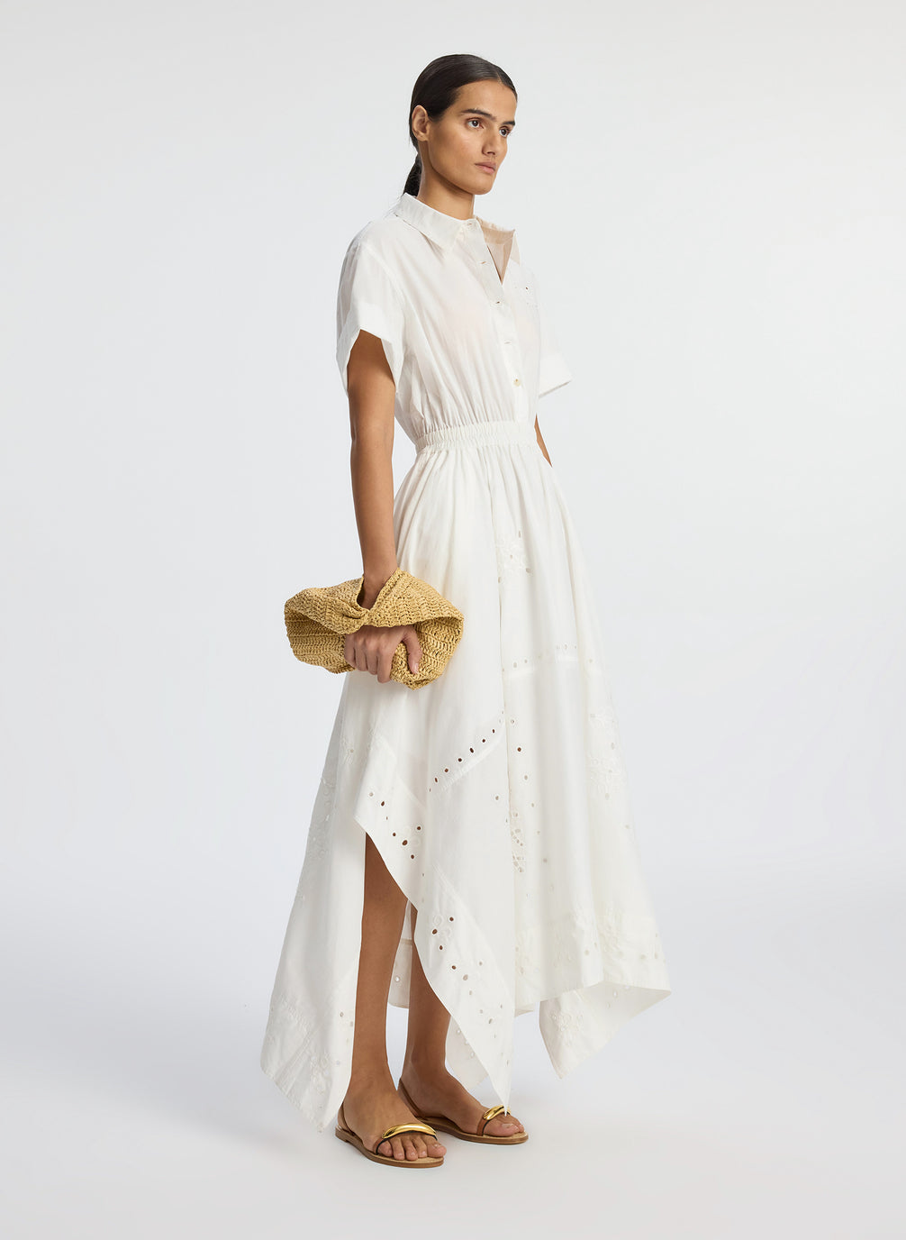 side view of woman wearing white embroidered short sleeve maxi dress