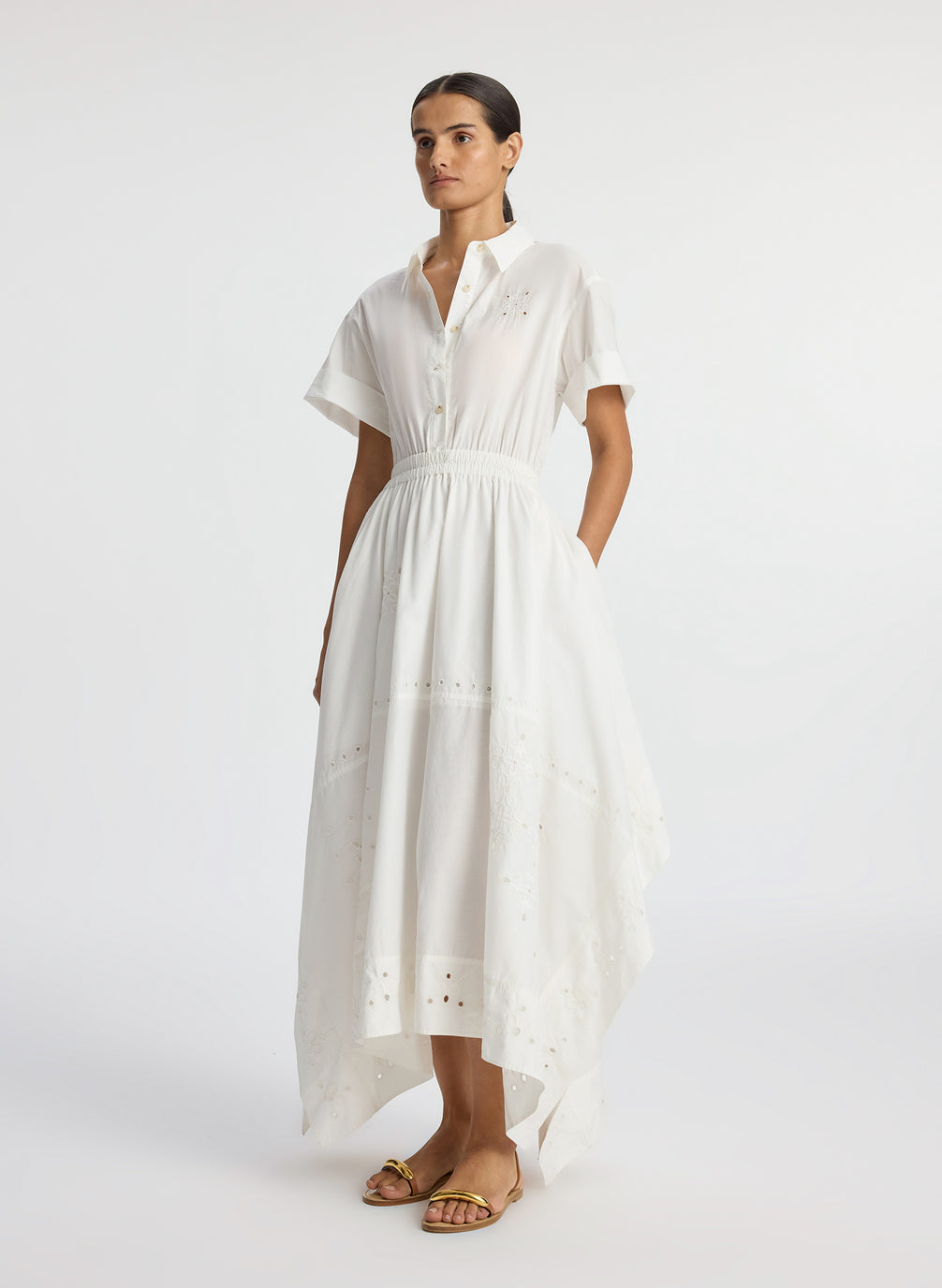 side view of woman wearing white embroidered short sleeve maxi dress