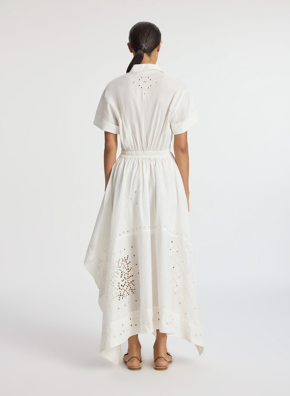 back view of woman wearing white embroidered short sleeve maxi dress