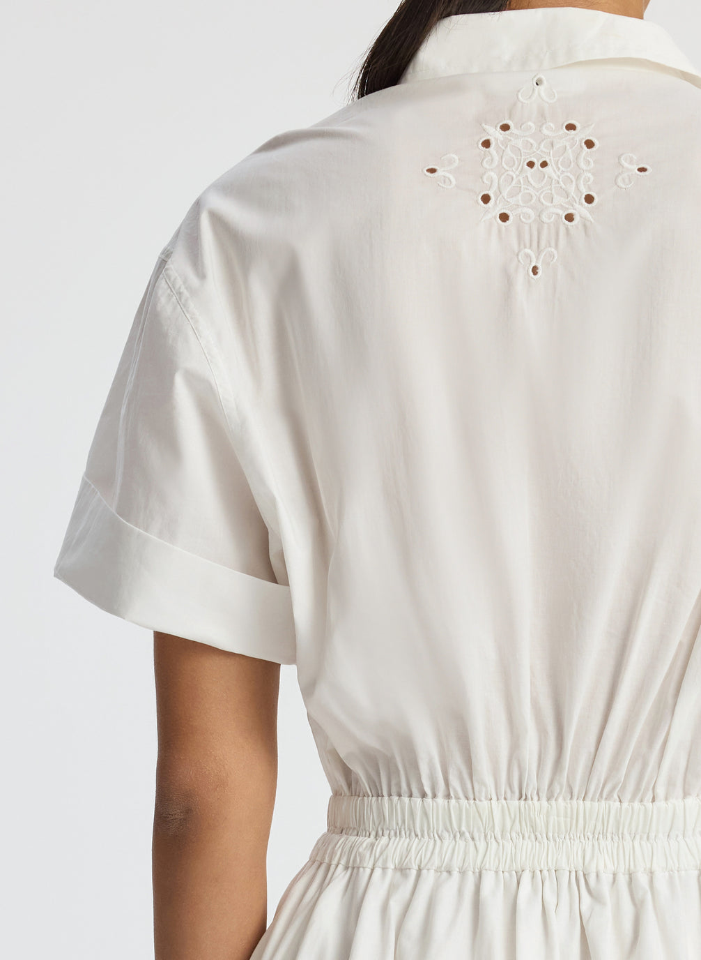 back detail view of woman wearing white embroidered short sleeve maxi dress