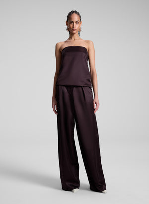 woman wearing brown strapless satin top and matching wide leg pants
