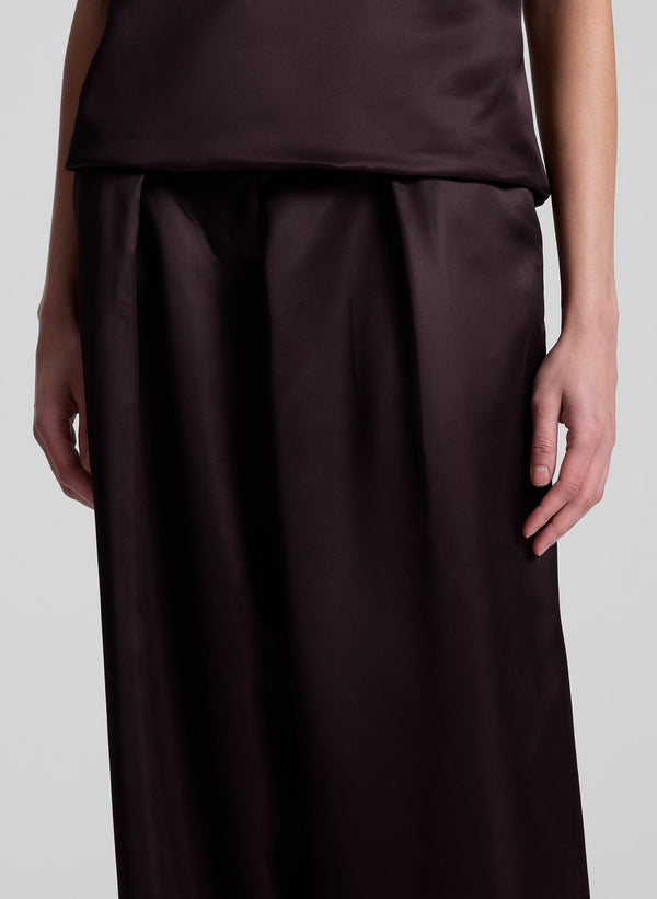 woman wearing brown strapless satin top and matching wide leg pants