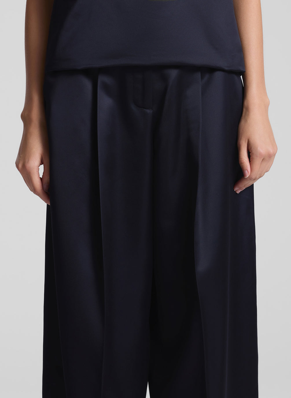 woman wearing navy blue strapless satin top and matching wide leg pants