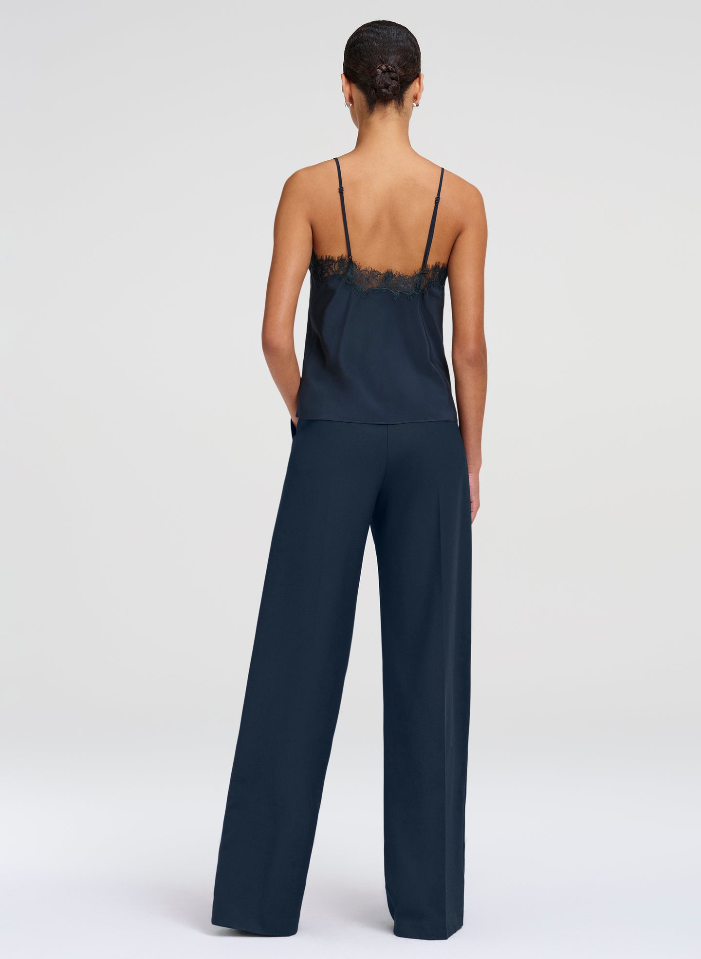 woman wearing dark green camisole top and green pants
