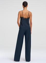 woman wearing dark green camisole top and green pants