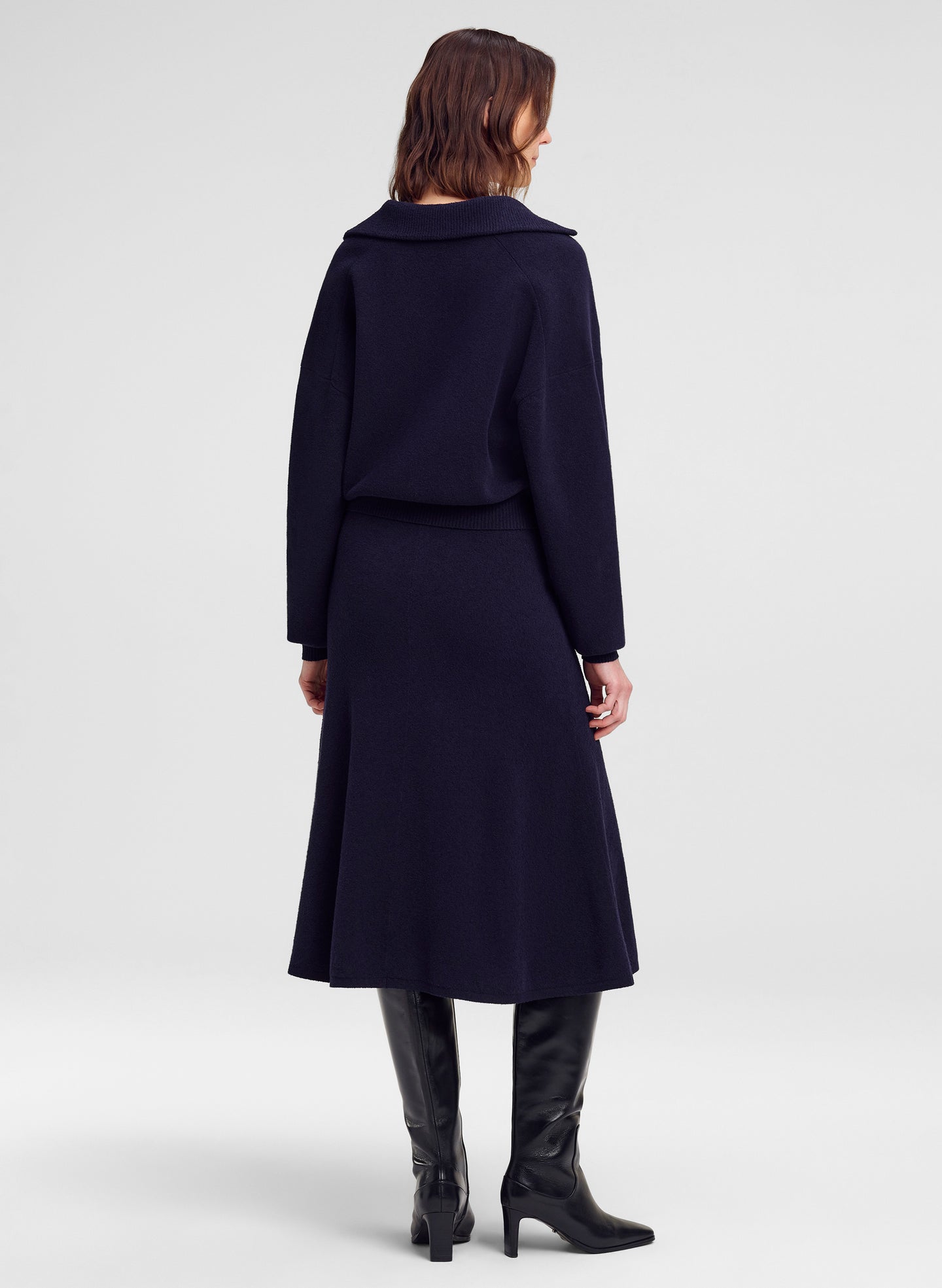 woman in navy blue sweater and matching skirt