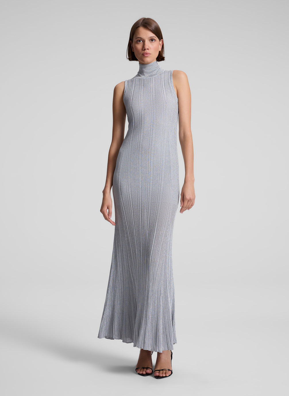 woman wearing silver sleeveless turtleneck maxi dress