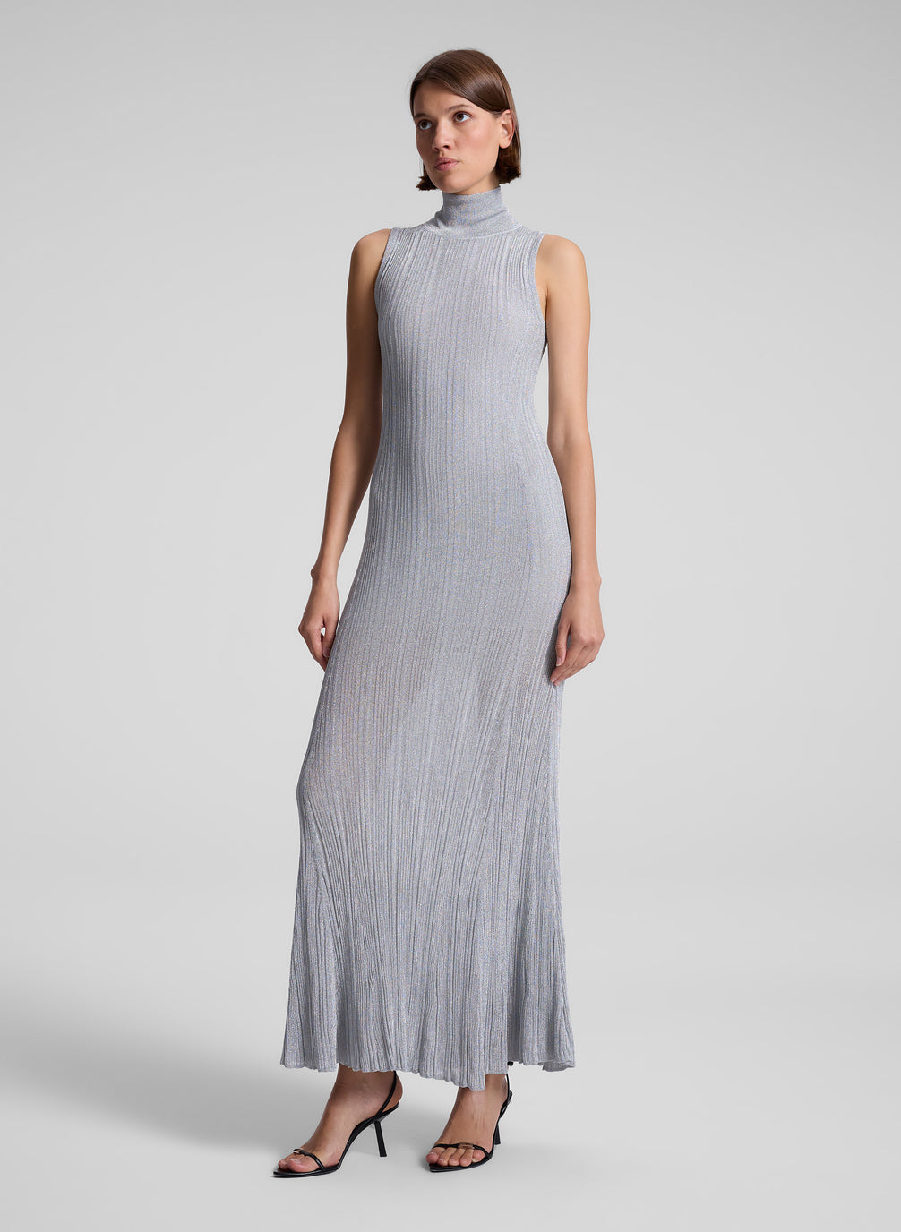 woman wearing silver sleeveless turtleneck maxi dress