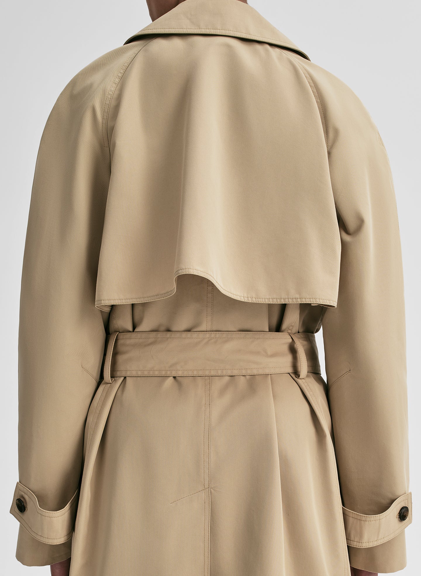 Beige trench coat on a white background
