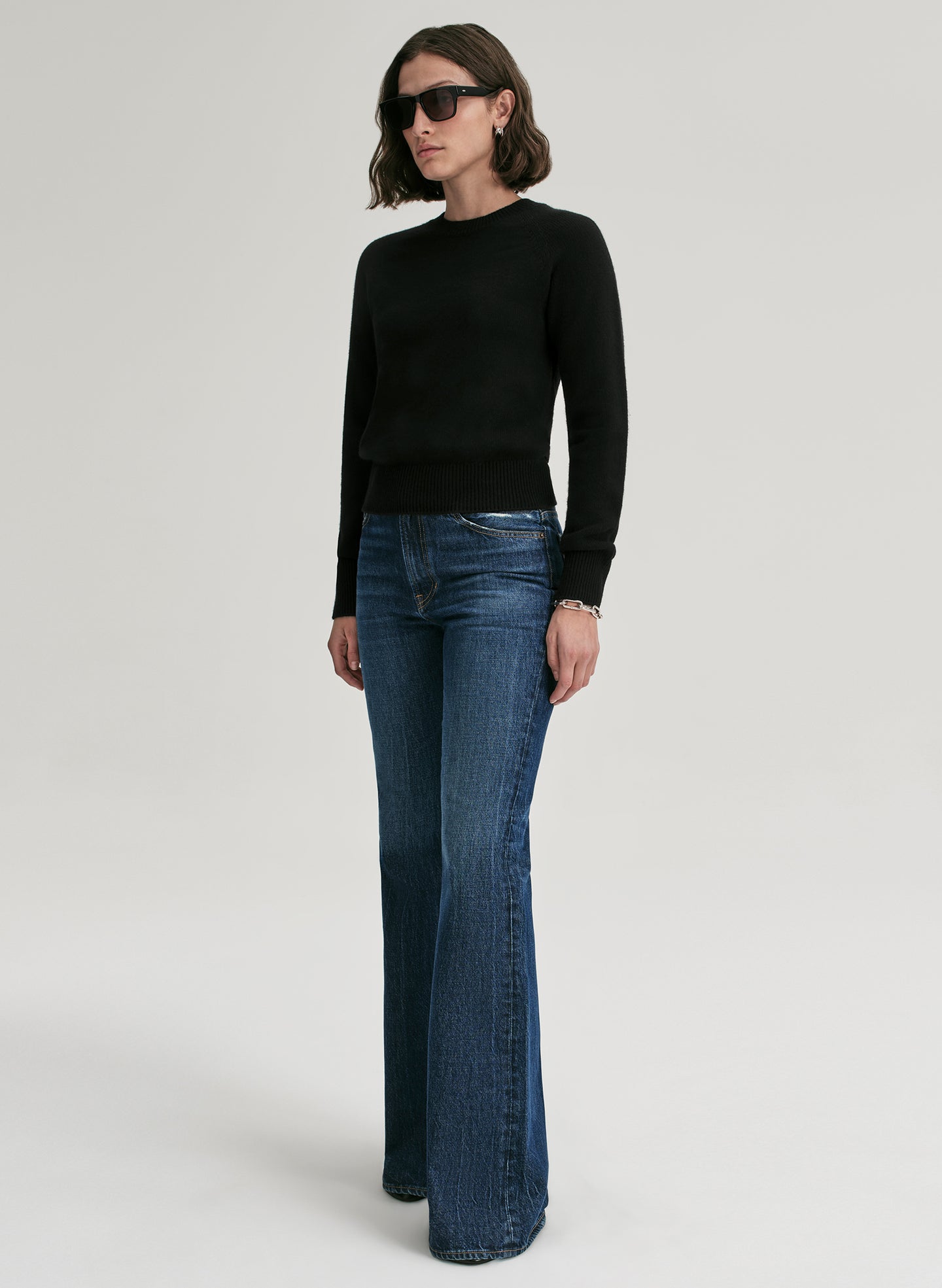 woman wearing black cashmere sweater and blue jeans