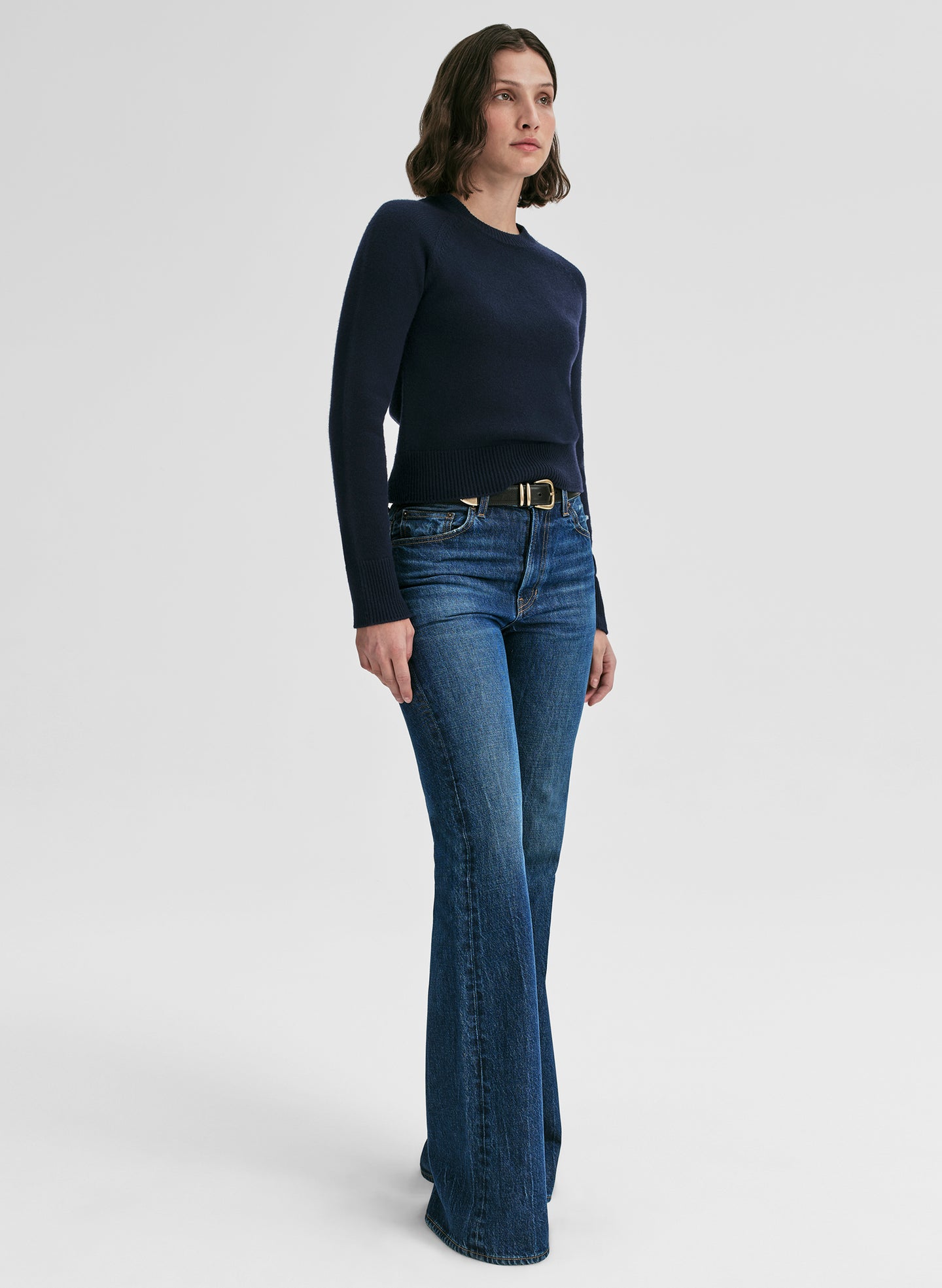 woman wearing navy blue sweater and jeans