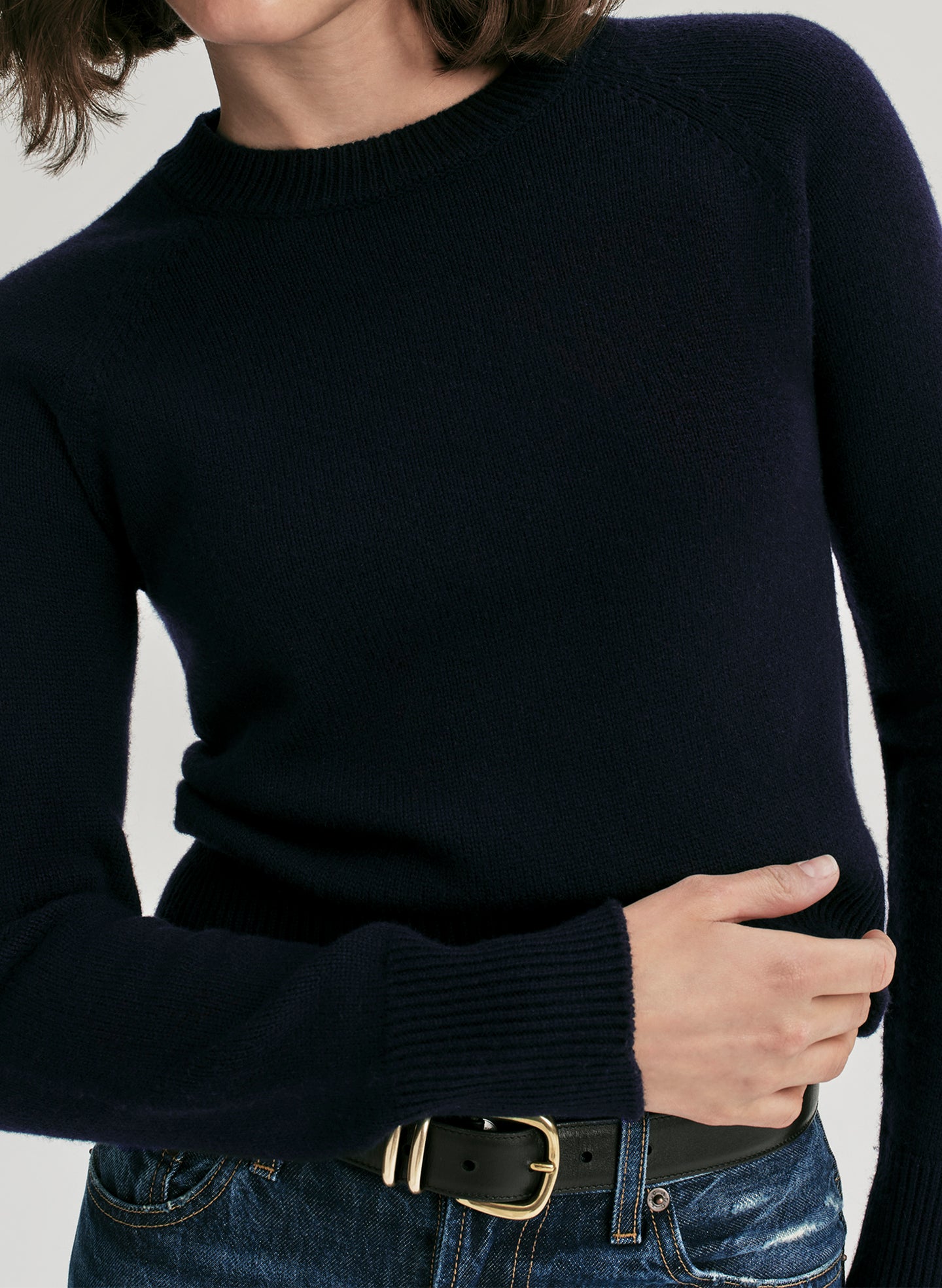 woman wearing navy blue sweater and jeans