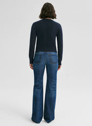 woman wearing navy blue sweater and jeans