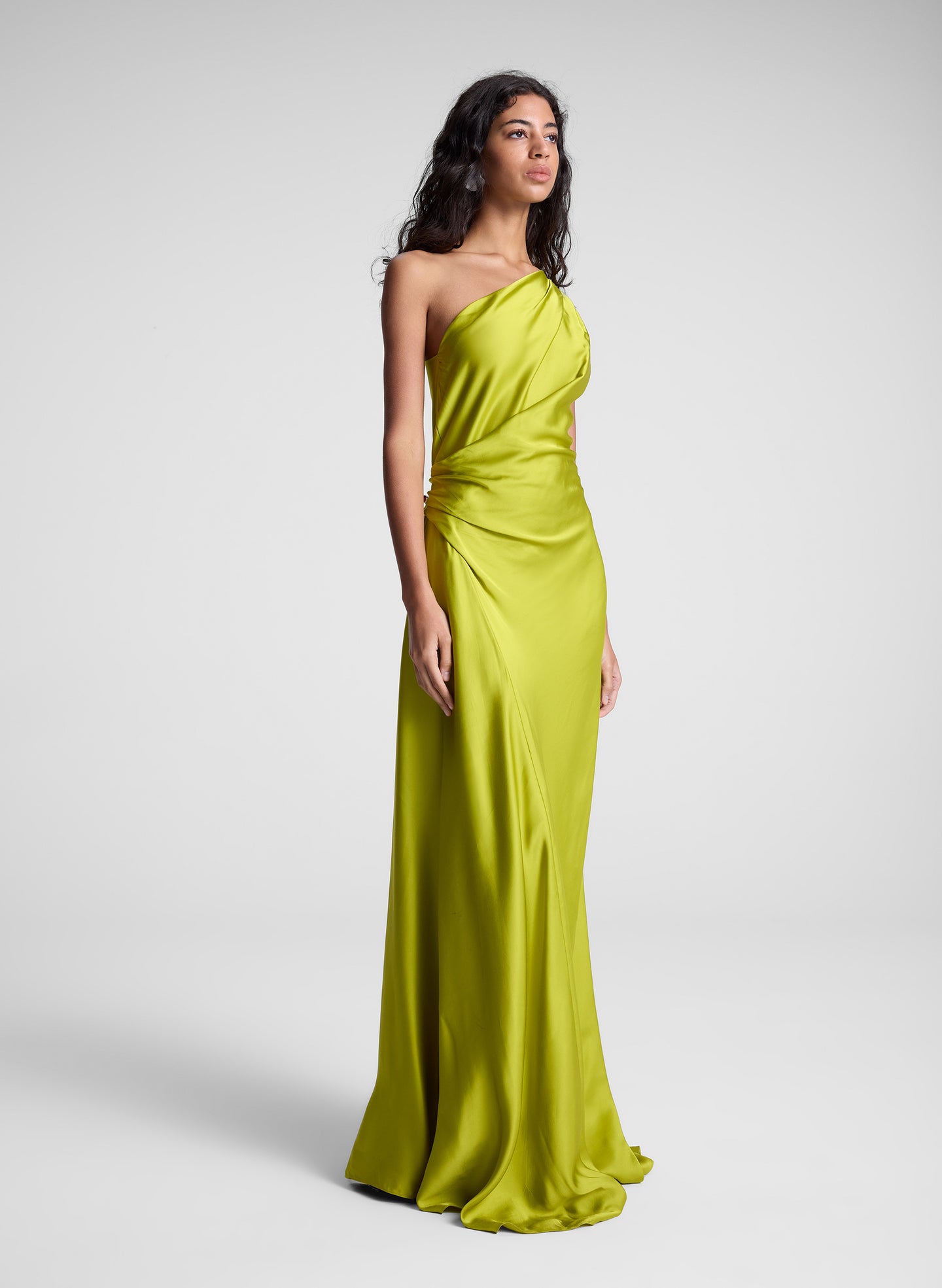 woman wearing green one shoulder maxi dress
