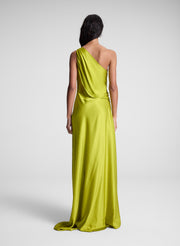woman wearing green one shoulder maxi dress