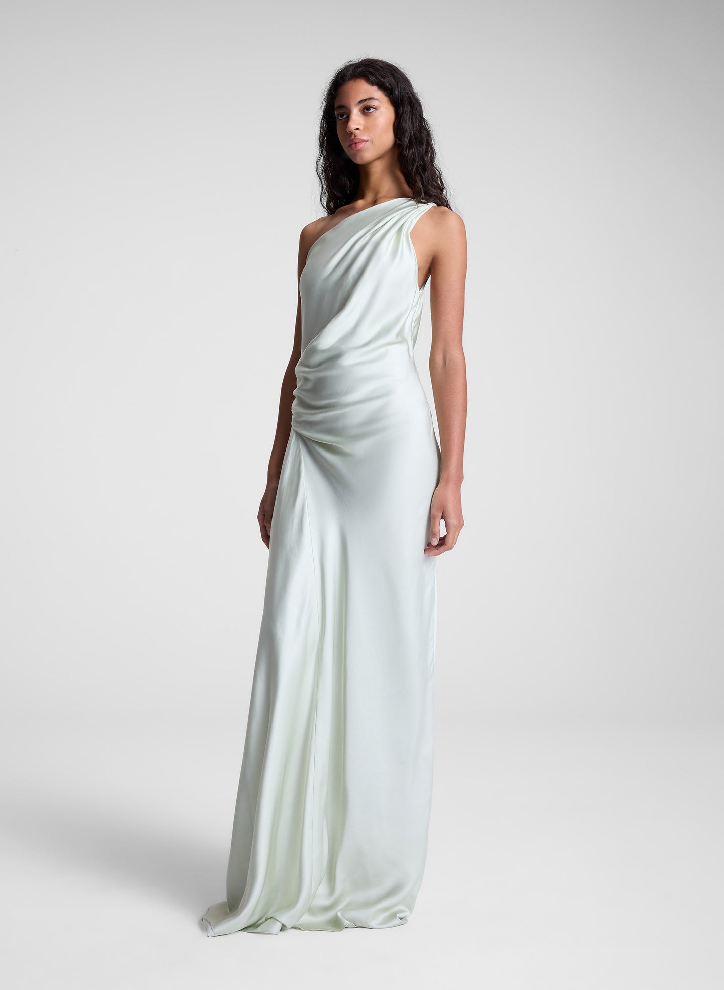 woman wearing green satin one shoulder gown