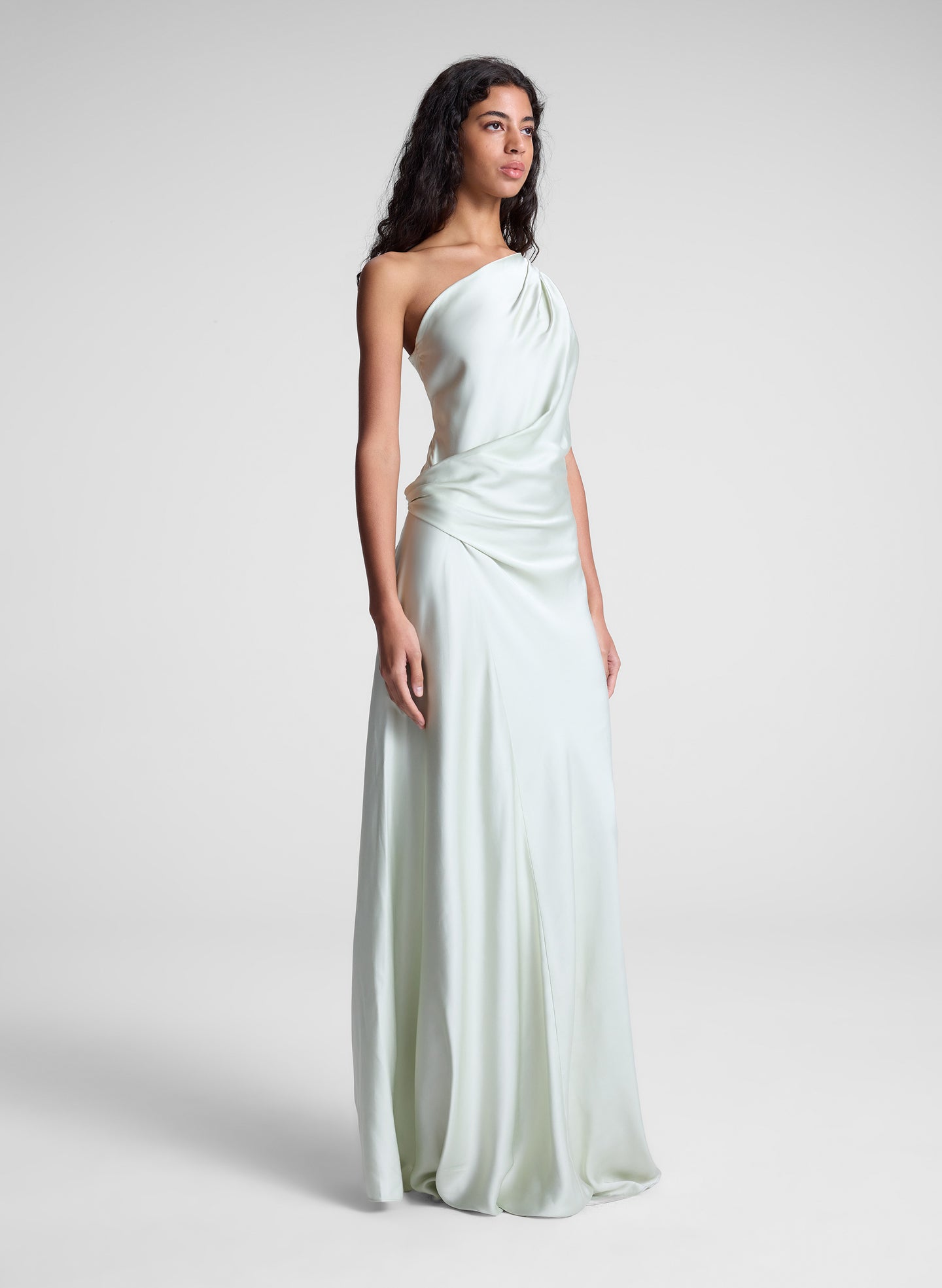 woman wearing green satin one shoulder gown
