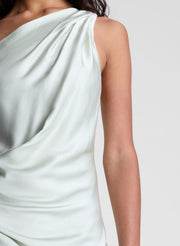 woman wearing green satin one shoulder gown