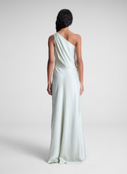 woman wearing green satin one shoulder gown