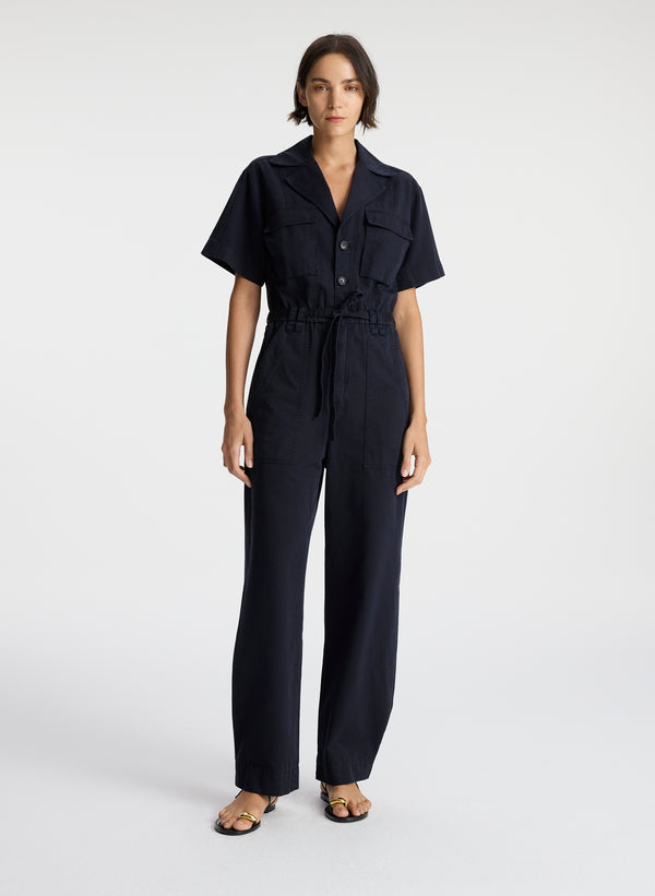 front view of woman in short sleeve navy blue jumpsuit