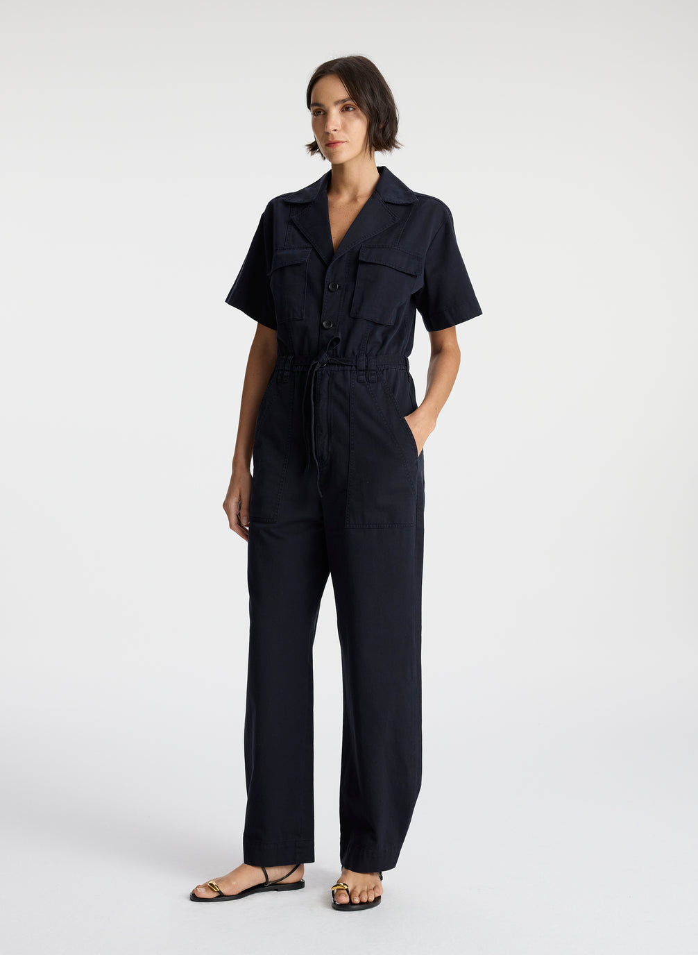 side view of woman in short sleeve navy blue jumpsuit