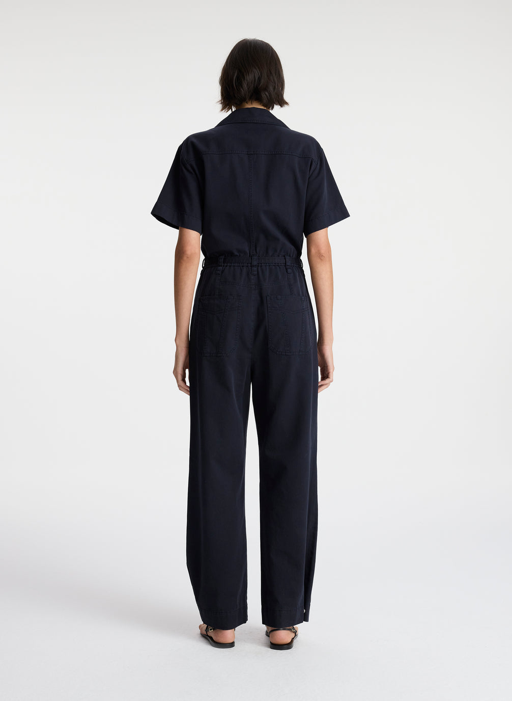 back view of woman in short sleeve navy blue jumpsuit