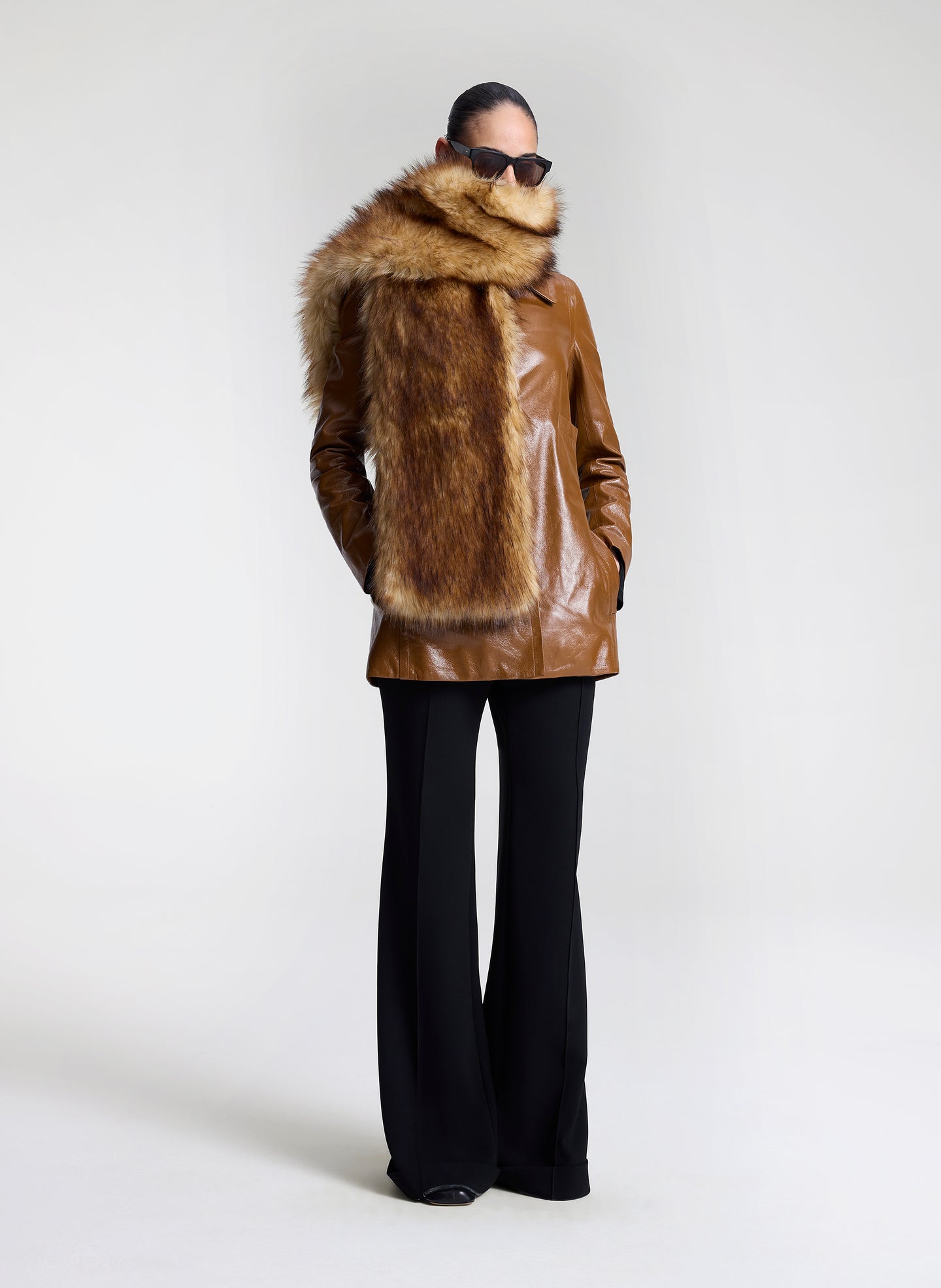 woman wearing faux fur scarf with leather jacket