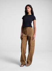 woman wearing black tee shirt and brown pants
